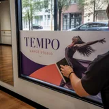 TEMPO dance studio window graphic being applied